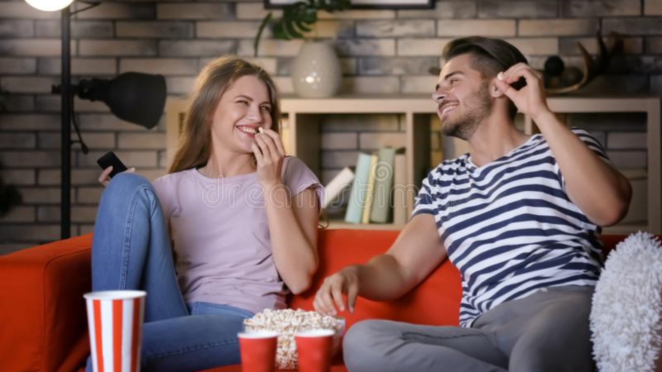young-couple-watching-tv-sofa-night-151155719